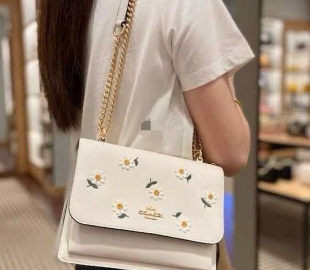 Coach Klare crossbody bag with daisy embroidery in white smooth leather with a gold-tone chain strap
