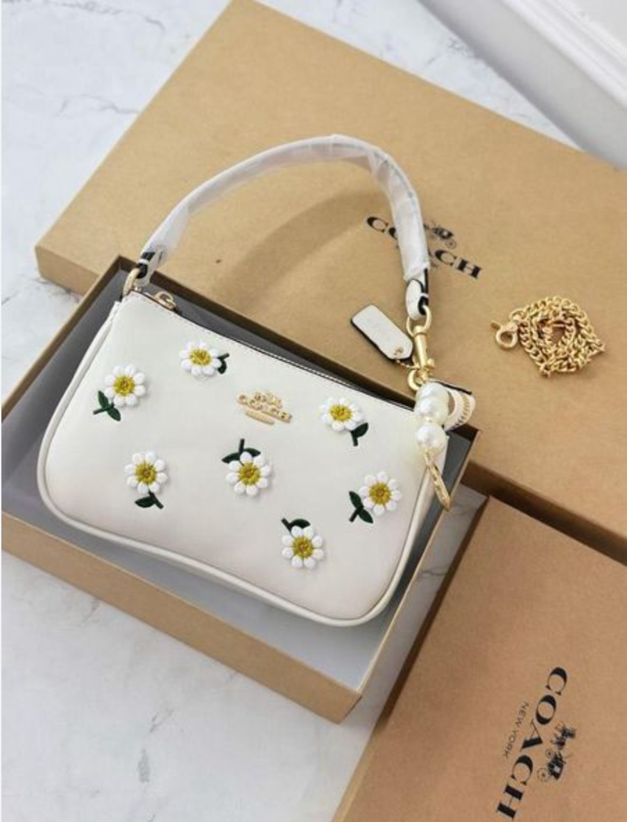 Coach Nolita 19 with Daisy Embroidery in refined pebble leather and white color.
